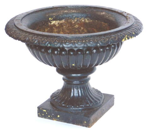 A Victorian cast iron garden vase or urn, of Campana form with egg and dart decoration to the rim and a fluted body, on a square base 39cm high, 54cm diameter.