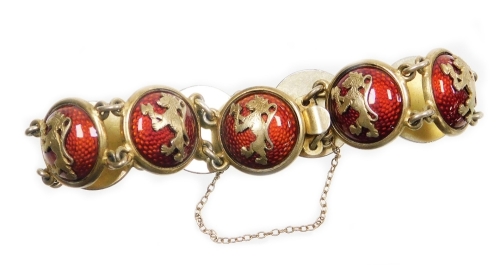 A Continental enamelled cabochon link bracelet, the bracelet formed of various circular links, each raised and finished in red enamel and applied with a rampant lion motif, with safety chain, the clasp stamped O.H.R, white metal marked 830S, approx 20cm l