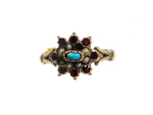 A Victorian dress ring, the centre set with garnets, seed pearls and a turquoise, on V splayed shoulders and a later misshapen yellow metal band, the band is made up of a split 22ct gold wedding band and crudely applied to the later ring setting which is