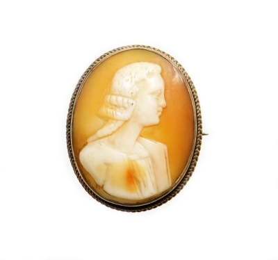 An early 20thC shell cameo brooch, depicting a figure head and shoulders profile, in a yellow metal frame, with rope twist border and single pin back, unmarked, 3.2cm x 2.8cm, 8.2g all in.