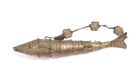 An early 20thC Eastern metal articulated fish, heavily cast and set with scales, with a chain hanger, unmarked, 35cm wide.