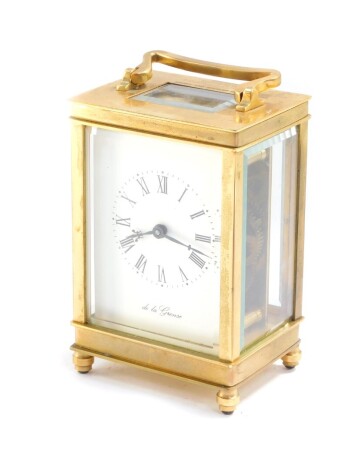 A brass carriage clock by De la Grense, of conventional form, dial bearing Roman numerals, case presentation engraved, with key, 13.5cm high, 8cm wide, 6cm deep.