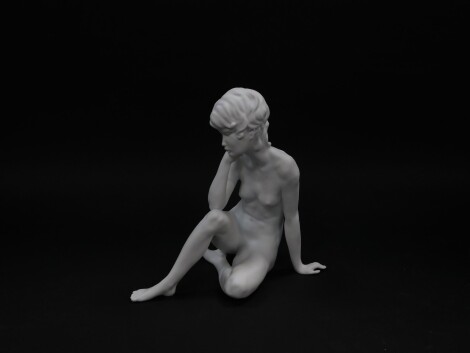 A Kaiser white bisque porcelain figure of a brooding girl, model no 489., impressed and printed marks, boxed.