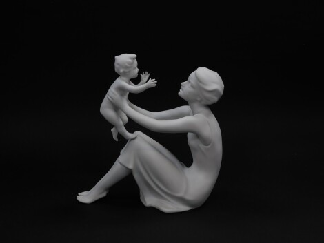 A Kaiser white matt bisque porcelain figure, modelled as Mother and Child, no 398., printed and impressed marks, boxed.