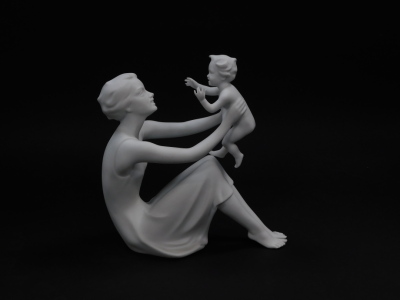 A Kaiser white matt bisque porcelain figure, modelled as Mother and Child, no 398., printed and impressed marks, boxed. - 2