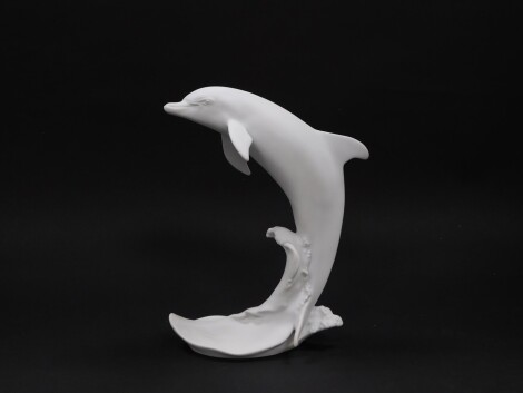 A Kaiser white matt bisque porcelain figure, modelled as a Dolphin, no 654., printed and impressed marks, boxed.