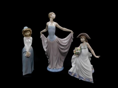 A Lladro porcelain figure modelled as Dancer, 05050., another modelled as Care Free, 05790., both boxed, together with a Nao figure modelled as a girl standing. (3)