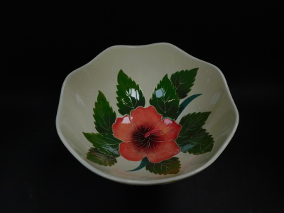 A Blue Sky pottery pedestal bowl decorated in the Hibiscus pattern, against a cream ground, printed marks, 24cm high, together with a dish moulded with a butterfly and flowers, printed marks, 31cm diameter (2). - 2