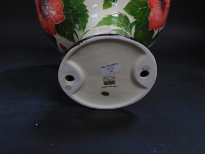 A Blue Sky pottery pedestal bowl decorated in the Hibiscus pattern, against a cream ground, printed marks, 24cm high, together with a dish moulded with a butterfly and flowers, printed marks, 31cm diameter (2). - 3