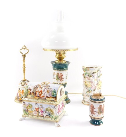 A Capo di Monte porcelain casket, of domed form, moulded with mythical figures, 18cm wide, together with an oval vase, 20cm high, a bell with a brass handle, 31cm high, an Italian pottery table lamp, with clear glass chimney and white glass shade, and a m