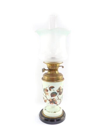 A Duplex late 19thC glass and brass oil lamp, painted with cob nuts against a pale green ground, with chimney and green to clear frosted glass frilled shade, 58cm high.