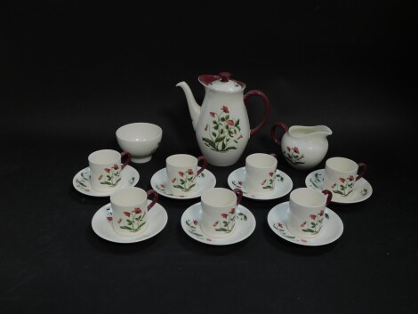 A Wedgwood pottery part coffee service decorated in the Mayfield pattern, comprising coffee pot, cream jug and sugar bowl, seven demi tasse coffee cans and saucers.