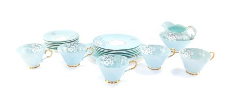 A Paragon porcelain early 20thC part tea service, decorated with white primroses against a turquoise ground, printed mark, comprising bread plate, cream jug and sugar bowl, five cups, six saucers and plates.