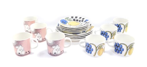 An Arabia pottery part breakfast service decorated in the Paratissi pattern, comprising four breakfast plates, four cups and saucers, together with four Arabia Moomin mugs.