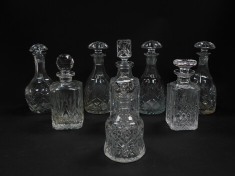 A set of three cut glass decanters, with mushroom shaped stoppers, a bell shaped decanter and stopper, and further decanters, with stoppers. (8)