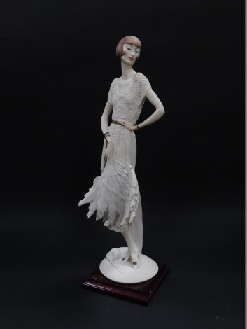 A Capo di Monte Florence figure of a lady, designed by Giuseppe Armani, modelled standing holding a fan, raised on a square wooden base, boxed with certificate, 47.5cm high.