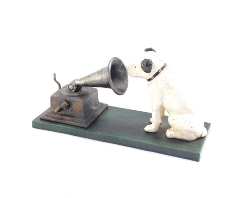 A replica cast iron HMV money box, modelled as seated dog looking to the horn of a gramophone, raised on a rectangular base, 22.5cm wide.