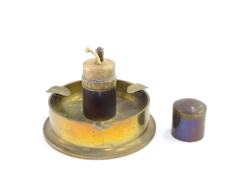 A Trench Art brass table lighter, on an integral ash tray base, 8.5cm high.