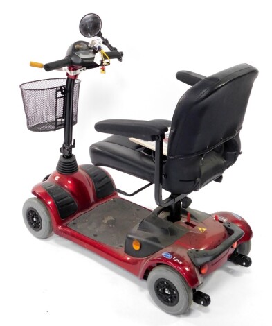 An Invacare Lynx Victory four wheeled mobility scooter, in red and black colourway, with front basket, adjustable seat, 90cm high.