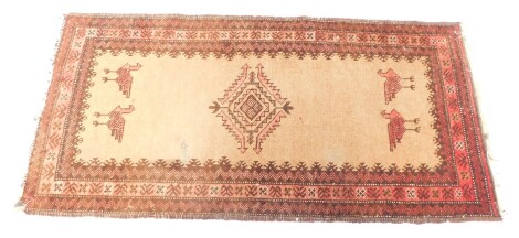 A 20thC Caucasian rug, of rectangular form, the inner field set with a diamond and birds, with outer geometric border in red and black, 108cm x 62cm.