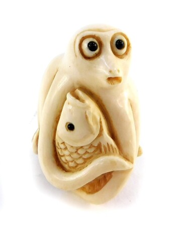 A Japanese late Taisho / early Showa period ivory netsuke of an octopus and carp entwined, signed, 36mm high.