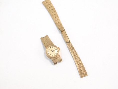 A Caravelle lady's 9ct gold wristwatch, circular gold dial bearing batons, on a bracelet strap, 17.0g all in.