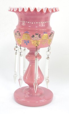 A 19thC pink glass lustre, with ribbon edged rim, painted body, baluster stem and circular foot with plain glass faceted drops, 35cm high.