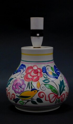 A 20thC Poole pottery table lamp, traditionally decorated with birds and flowers, 17cm high.