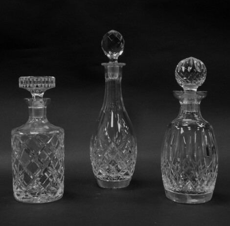 Various 20thC crystal decanters, to include a shouldered circular example with compressed mushroom stopper and a repeat hobnail cut geometric pattern, 24cm high, another with crystal orb stopper, etc. (3)