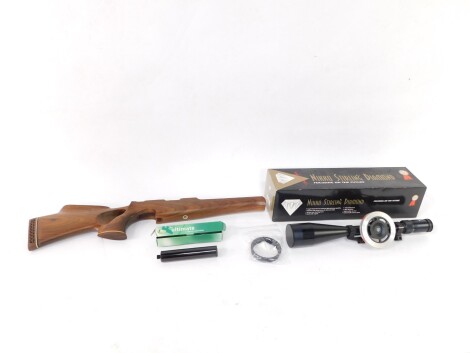 A Nikko Sterling Diamond gun sight, 47cm wide, a Falcon silencer and a plain stock. (3, 2 boxed)