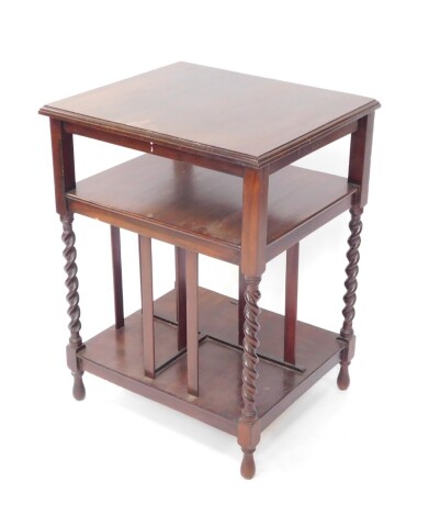 An early 20thC mahogany newspaper rack, of square form with open top and sections for newspapers beneath, on barleytwist legs terminating in teardrop feet, 74cm high, 51cm wide, 58cm deep.