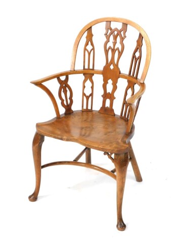 A Gothic style yew and elm Windsor chair, the hooped back with a shaped pierced splat flanked by further arched piercings, with shaped arms and similar pierced supports, with crinoline stretcher on cabriole front pad feet, 93cm high.