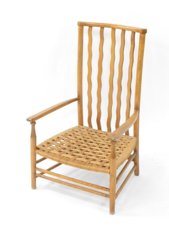A 20thC rush seated low chair, with vertical shaped back splats, on turned legs joined by vertical stretchers, 79cm high.