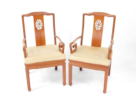 A pair of Chinese hardwood carver chairs, each with vertical pierced back splats, plain cylindrical frames, stylised shepherd's crook arms, and square front legs, with floral cushions, 97cm high.