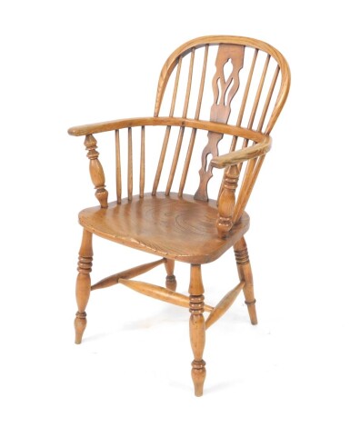 A 20thC ash and elm low back Windsor chair, with pierced fret work style splat, plain turned spindles, triple ring turned front legs joined by H stretcher, 93cm high.