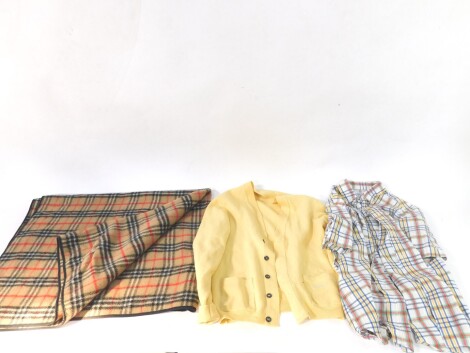 A Burberrys 100% pure lamb's wool cardigan, in yellow, 102cm,, a short sleeved shirt, and a Burberry rug. (3)