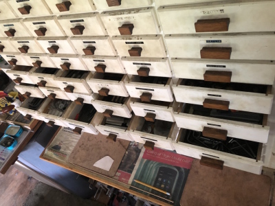 A bank of eighty six white painted drawers, containing engineering objects, ranging from circlips, carbide tips, HRD bushes, ballraces, centres, plug gauges, springs, drills, calipers, centre drills, taps, dies, needle rollers, tool bit blanks, precision - 3