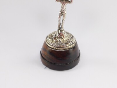 A Continental late 19thC novelty table clock, circular enamel dial bearing Arabic numerals, centre seconds, chased brass cased visible movement, the circular white metal casing foliate engraved, held aloft by a figure of Harlequin standing on a Rococo scr - 3