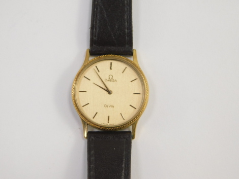 An Omega De Ville gentleman's gold plated wristwatch, circular dial bearing gilt batons, on a leather strap, with guarantee, cased.