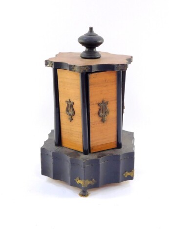 A late 19thC French ebonised dressing table compendium, with articulated knop, revealing several openings with space, each set with three loops, on a shaped base terminating on compressed orb feet, 31cm high. (AF)