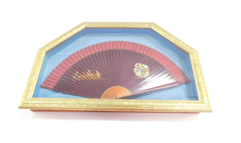 An early 20thC Chinese presentation fan, with various signatures, the centre set with various figures in flowing robes, in a glazed case, 34cm high, 49cm wide, 8cm deep.