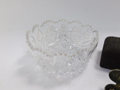 An early 20thC star cut glass bowl, with shaped top, diamond geometric body, 21cm wide, an oval box repousse decorated with dog in forest setting, metal mount with photographic centre, cigarette box, etc. (a quantity) - 2