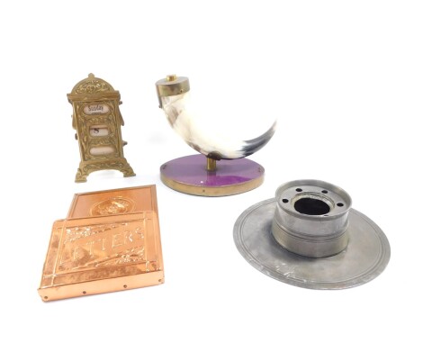 Metalware and collectables, comprising a 20thC Art Nouveau brass desk calendar with articulated date and cloth interior, 19cm high, a copper letter rack, pewter ink stand and a full horn flask on stand. (4)