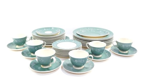 A Royal Doulton pottery part dinner and tea service decorated in the Cascade pattern, comprising eight dinner and dessert plates, sauce boat stand, six tea cups, eight saucers, nine tea plates and a bread plate.