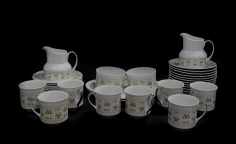 A Royal Doulton porcelain tea service decorated in the Samarra pattern, comprising a pair of bread plates, a pair of cream jugs, eight tea cups, twelve saucers and nine tea plates, together with a Crown Staffordshire porcelain vase decorated with flowers.