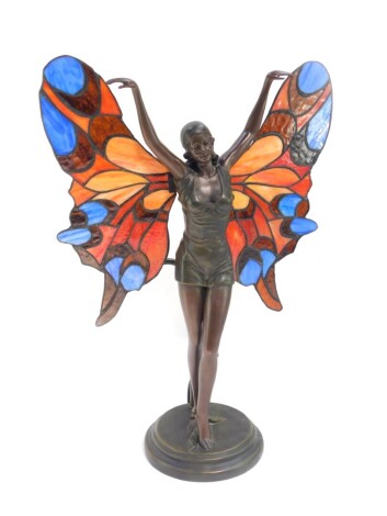 An Art Nouveau style bronzed figural fairy table lamp, moulded in standing pose with stained glass wings, 42cm high.