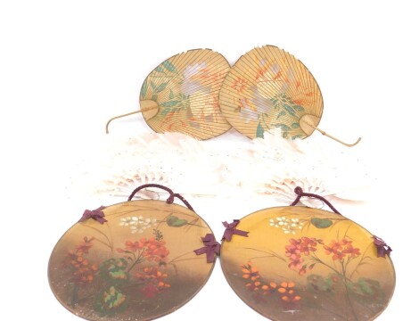 A pair of painted pink Marabou feather fans, 37cm diameter, a pair of circular painted fabric screens, 26.5cm diameter, and a pair of Oriental printed paper fans, with bamboo handles, 38cm high. (AF)