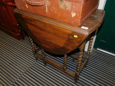 An oak barley twist drop leaf table, 72cm high, 38cm wide, 108cm extended, 75cm deep.