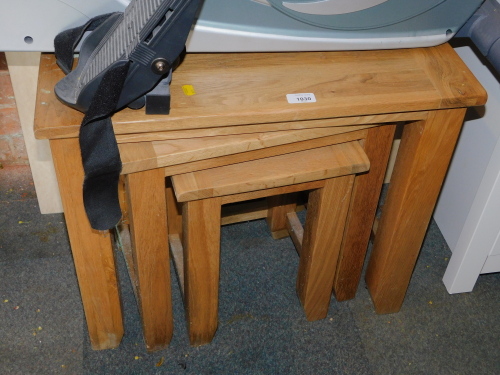 A blonde oak nest of tables, largest 52cm high, 61cm wide, 38cm deep.