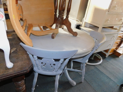 A pine circular kitchen table, painted blue, 75cm high, 105cm diameter, together with four chairs and a carver. (6)